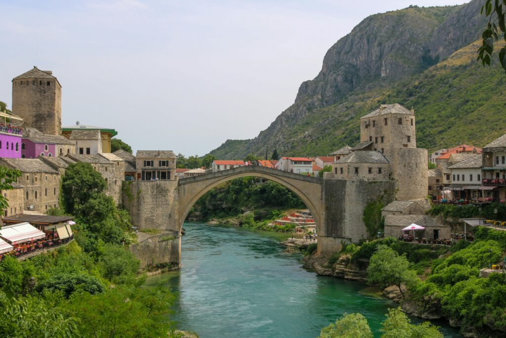 Charming view of Mostar's Old Bridge over the Neretva River, surrounded by medieval buildings.
