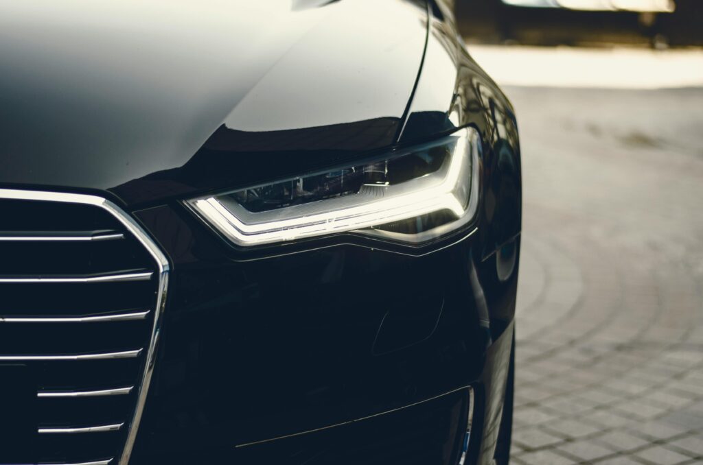 pexels-photo-305070-305070 A sleek, modern luxury car showcasing its chrome detailing and LED headlights on a city street.
