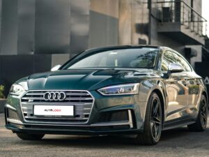 Sleek black Audi S5 sports car parked outdoors showcasing its modern design and luxury features.