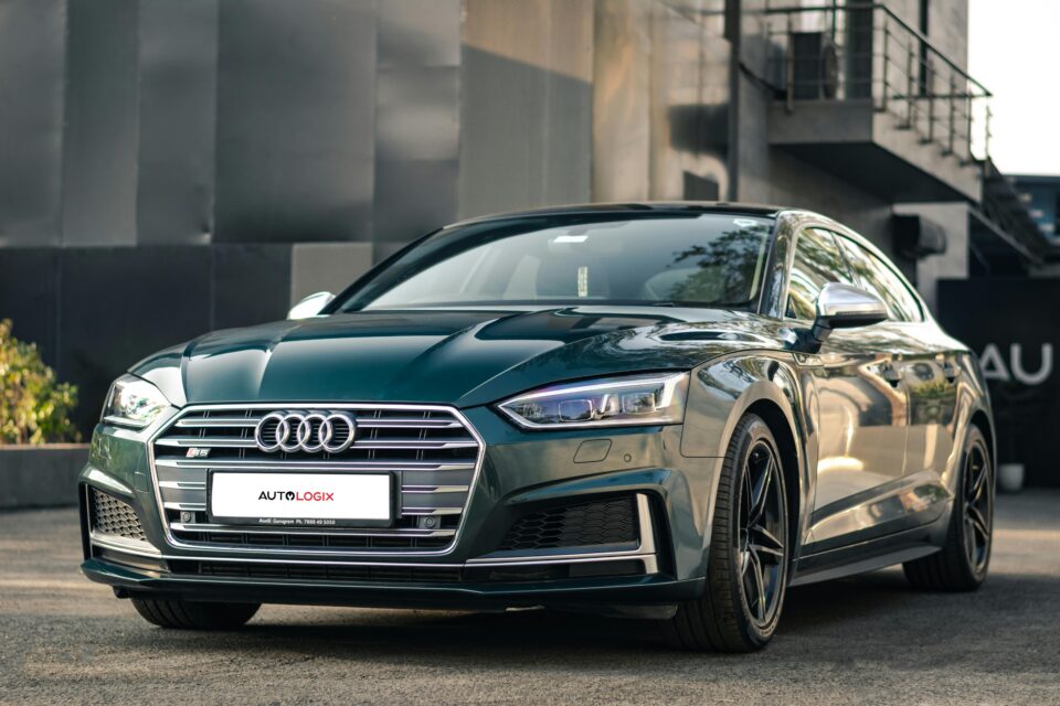 Sleek black Audi S5 sports car parked outdoors showcasing its modern design and luxury features.