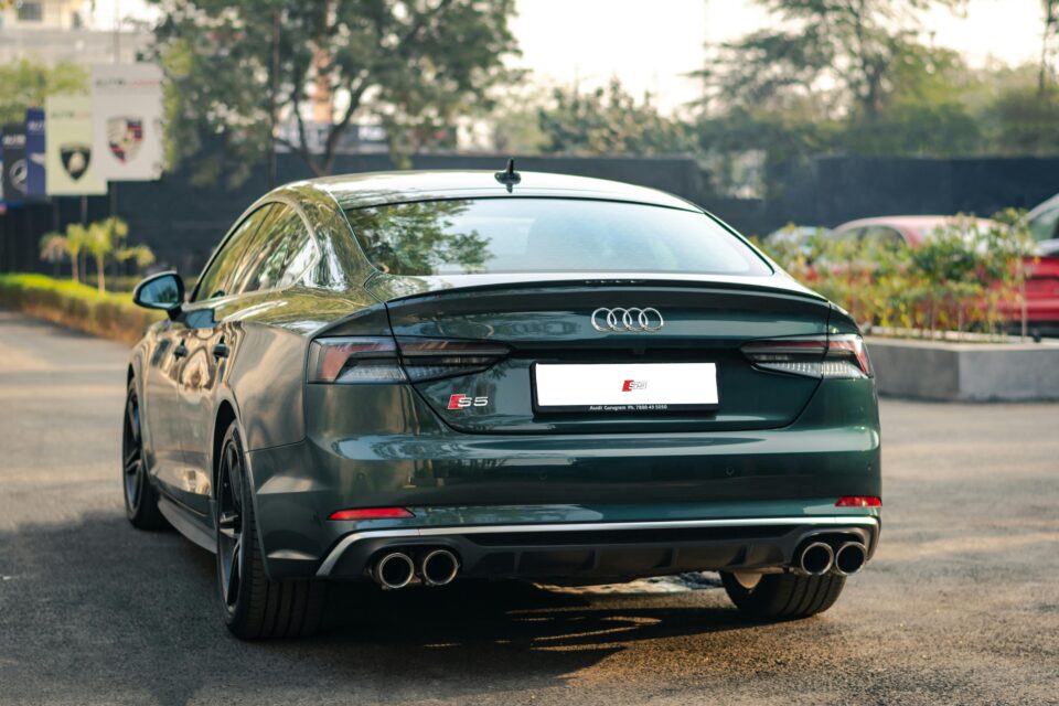Rear view of a luxurious Audi car parked outdoors during daytime, showcasing elegance.